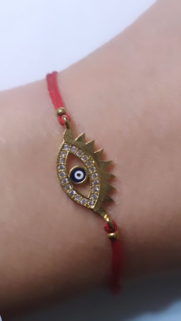 Ojo turco latón baño oro cristal austríaco.