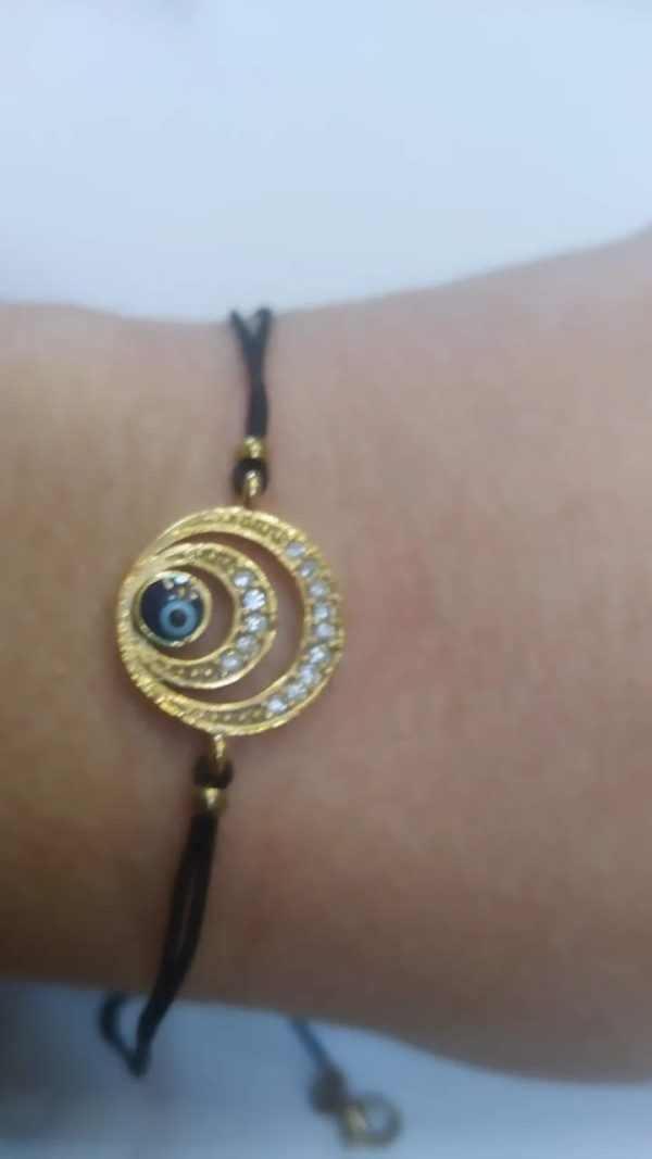 Ojo turco, latón baño oro cristal austríaco, negra.